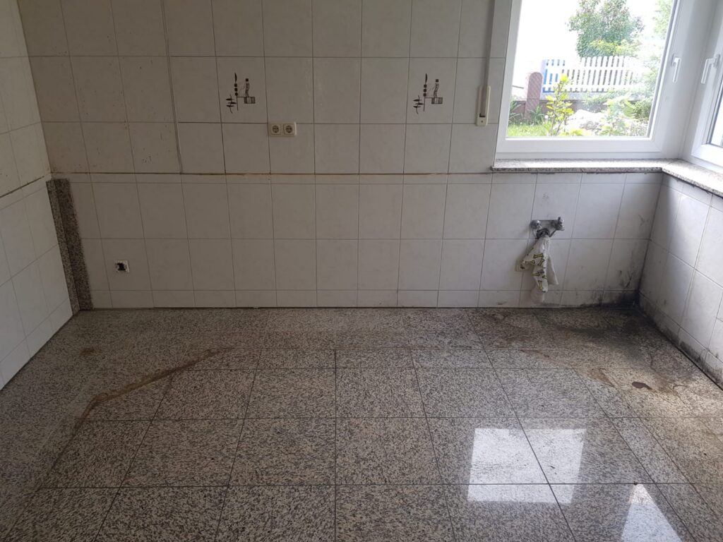 Leere Küche mit Granitboden nach Küchenabbau und Haushaltsauflösung